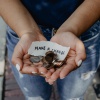 Hands holding coins